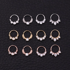 Detailed grid of 12 tribal septum rings in silver, gold, and rose gold with zircon