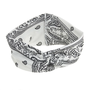 Close-up of white bohemian headband featuring black paisley print and twist knot design