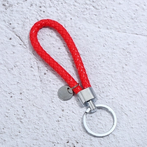 Handcrafted red braided leather keychain with shiny silver metal ring and circular tag