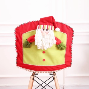 Detail of red and green Christmas chair cover with 3D Santa Claus figure on wooden chair