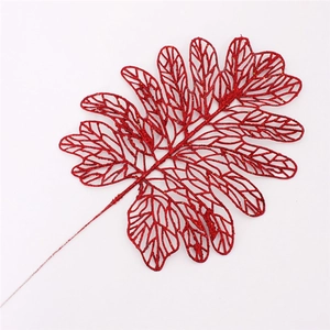Close-up of glittery red Persian leaf Christmas tree topper with hollow veins and stem