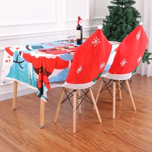 Christmas dining set featuring festive tablecloth and snowflake chair covers in home setting