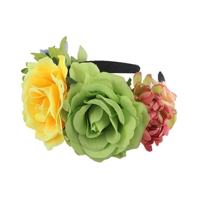 Detail view of colorful faux roses and green leaves on a black festive headband base