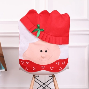 Festive red Christmas chair cover with a cute gnome design and a green bow decoration