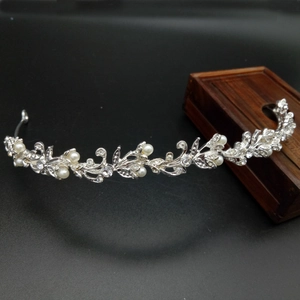 Detailed macro view of silver bridal crown with white pearls and sparkling crystals