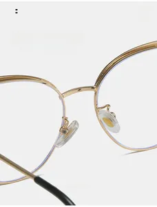 Close-up of golden metal glasses frame featuring soft silicone nose pads for comfort