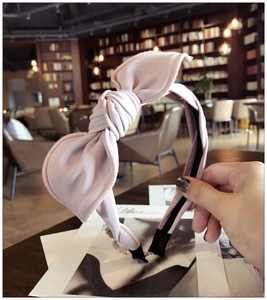 Detailed texture of light purple fabric bow headband with cute rabbit ear style design