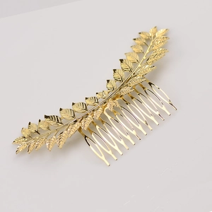 Elegant gold metal hair comb featuring detailed leaf design for vintage hairstyles