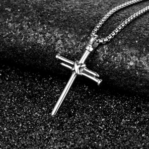 Classic silver stainless steel cross pendant necklace with box chain on dark background