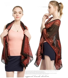 Detail view of red and black paisley chiffon shawl with delicate floral patterns