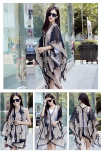 Detail of lightweight paisley chiffon sun shawl with batwing sleeves and black trim edge
