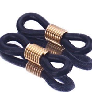 Macro shot of black silicone anti-slip loops with golden metal coils for DIY eyewear chains
