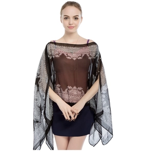 Close-up of semi-transparent black chiffon sun shawl with grey paisley patterns and pearl buttons