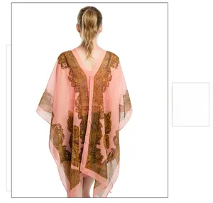 Detail of light pink paisley print chiffon beach shawl with a loose bohemian v-neck design