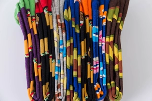 Close-up of colorful cotton socks featuring vibrant hamburger patterns and ribbed texture
