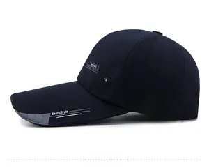 Side view of dark blue sports baseball cap with long visor and fashion lettering