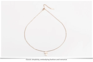 Detail of rose gold cross pendant necklace showing the K18 hallmark on the clasp