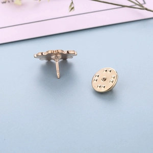 Macro shot of rose gold butterfly clutch back and metal pin for enamel floral brooches