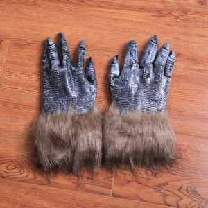 Halloween werewolf gloves with brown faux fur and long sharp claws on wooden background