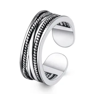 Macro view of silver adjustable multi-layer ring featuring twisted rope texture details