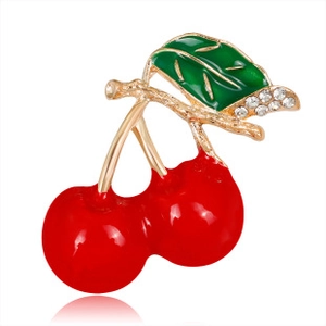 Detailed view of elegant cherry brooch with red enamel and sparkling crystal accents