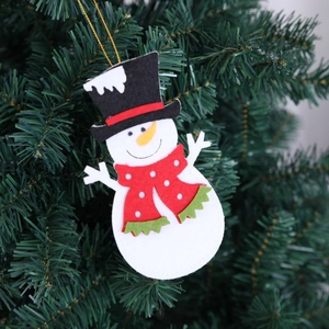 Close-up of a felt snowman ornament with a red polka dot scarf on a Christmas tree