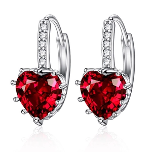 Sparkling heart-shaped red zircon earrings with silver metal pavé setting on white background