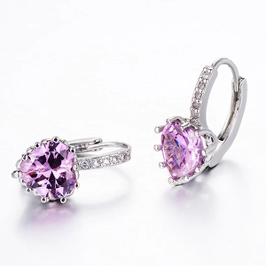 Close-up of pink heart-shaped crystal earrings with micro-pave cubic zirconia accents