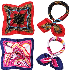 Detail view of red chain and navy geometric printed satin silk square scarves