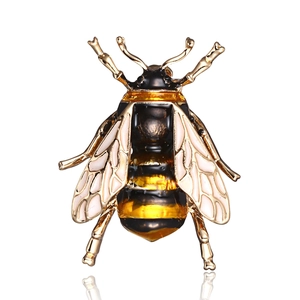Detailed close-up of a golden alloy bee brooch featuring black and yellow enamel patterns