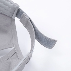 Detail of adjustable Velcro strap on a grey cotton twill baseball cap with neat stitching