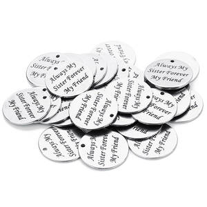 Macro detail of silver round charms with Always My Sister Forever My Friend engraving