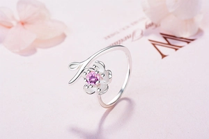 Close-up of cherry blossom open ring featuring pink stone and s925 silver stamp