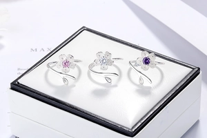 Macro detail of adjustable cherry blossom rings with inlaid zircons in white jewelry box