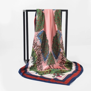 Detail of elegant satin square scarf with floral pattern draped on a metal frame