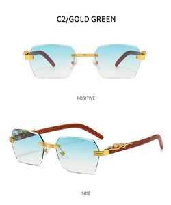 Detail of rimless blue gradient lens sunglasses with gold leopard head decor and wood temples