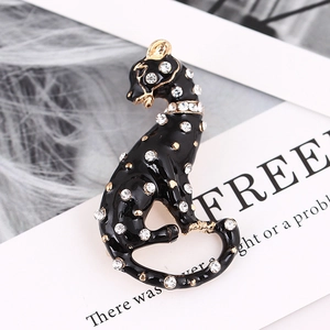 Elegant leopard brooch featuring black enamel with white crystals and gold plating