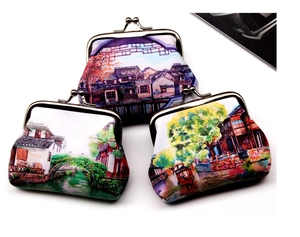 Detailed view of three vintage kiss-lock coin purses with scenic oriental art prints