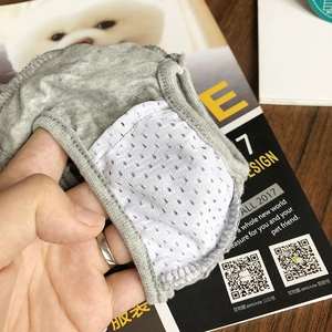 Detail of dog sanitary pants showing breathable white mesh lining and gray cotton fabric