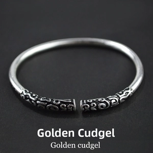 Detailed macro view of retro stainless steel Golden Cudgel bracelet with cloud carvings