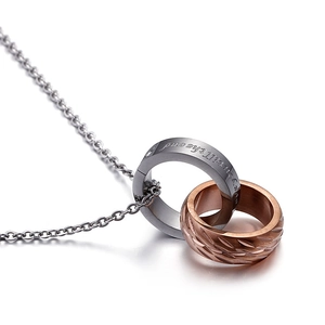 Interlocking double ring pendant necklace in silver and rose gold steel on white background
