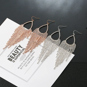 Detailed view of silver and rose gold teardrop rhinestone fringe tassel earrings