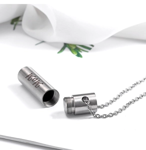 Close-up of MOM engraved stainless steel cylinder urn necklace for ashes with fine chain