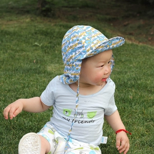 Detail view of the blue whale print sun hat with protective neck flap for babies