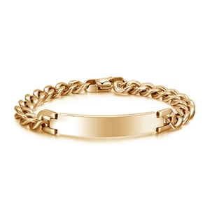 Macro detail of golden stainless steel Cuban chain bracelet with a blank ID plate