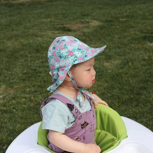 Detail of baby sun hat with floral dragonfly prints and adjustable chin strap