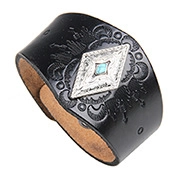 Detail of black embossed leather wristband with silver eagle plate and turquoise stone