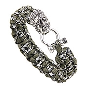 Detail of woven army green camouflage paracord bracelet with metal tribal charm