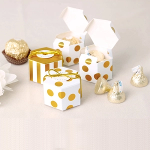 Hexagonal white gift boxes with gold foil dots and stripes, including elastic cords