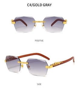 Detail of rimless rectangle sunglasses with wood temples and gold leopard ornament